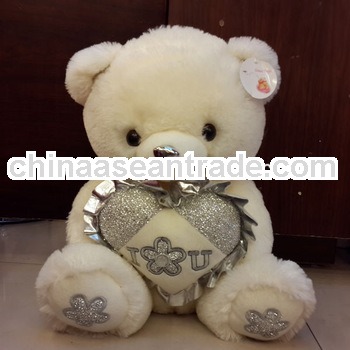 Promotional cream-colored plush bear toy with a heart for lovers