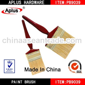 red varnished round handle decking paint brush